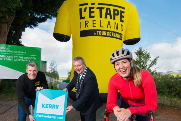 Mayor of Kerry- Councillor Breandán Fitzgerald, Oliver Kirwan from L’Etape Ireland, and Sarah Ann Egan from Roadman Podcast beside the Kingdom of Kerry Greenways sign.